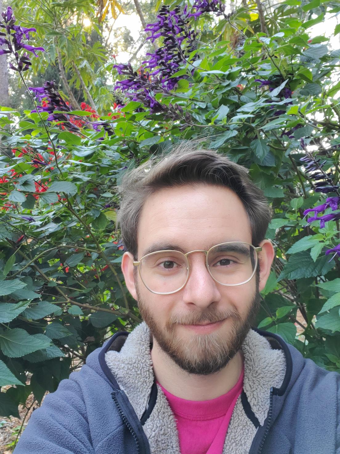 Selfie in front of purple flowers at Mead Botanical Gardens.